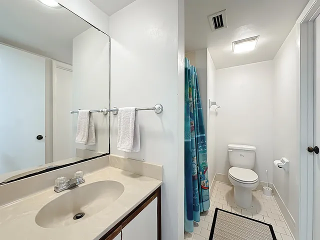 a spacious bedroom with a bed and window