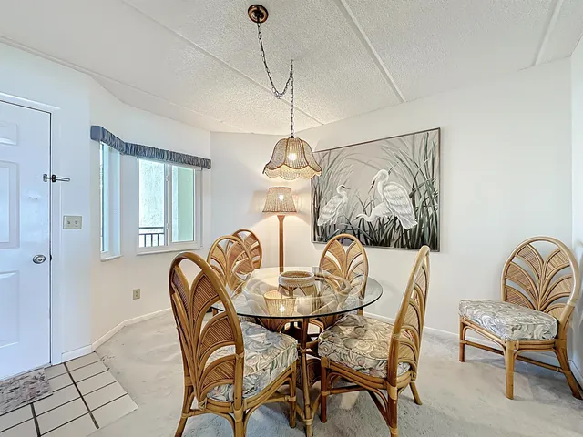 a large white kitchen with a stove a sink dishwasher and a refrigerator with wooden floor