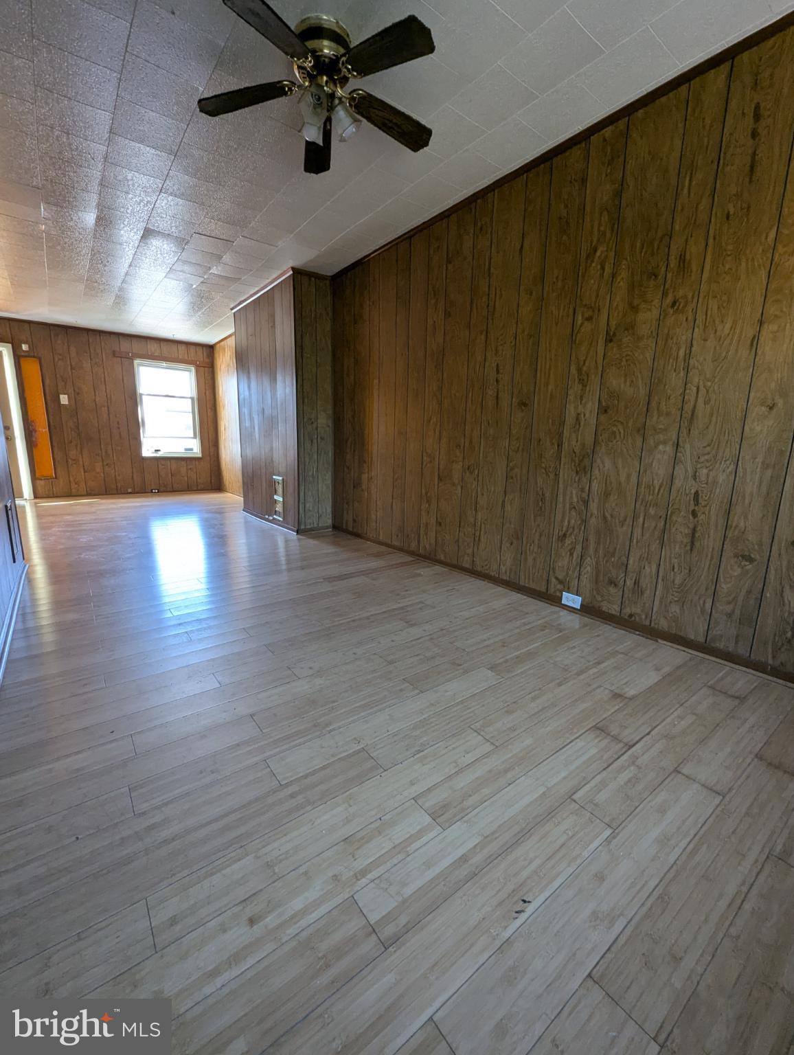 2650 South 68th Street Philadelphia, PA 19142 - Photo 4 of 12 a view of an empty room with wooden floor and a window