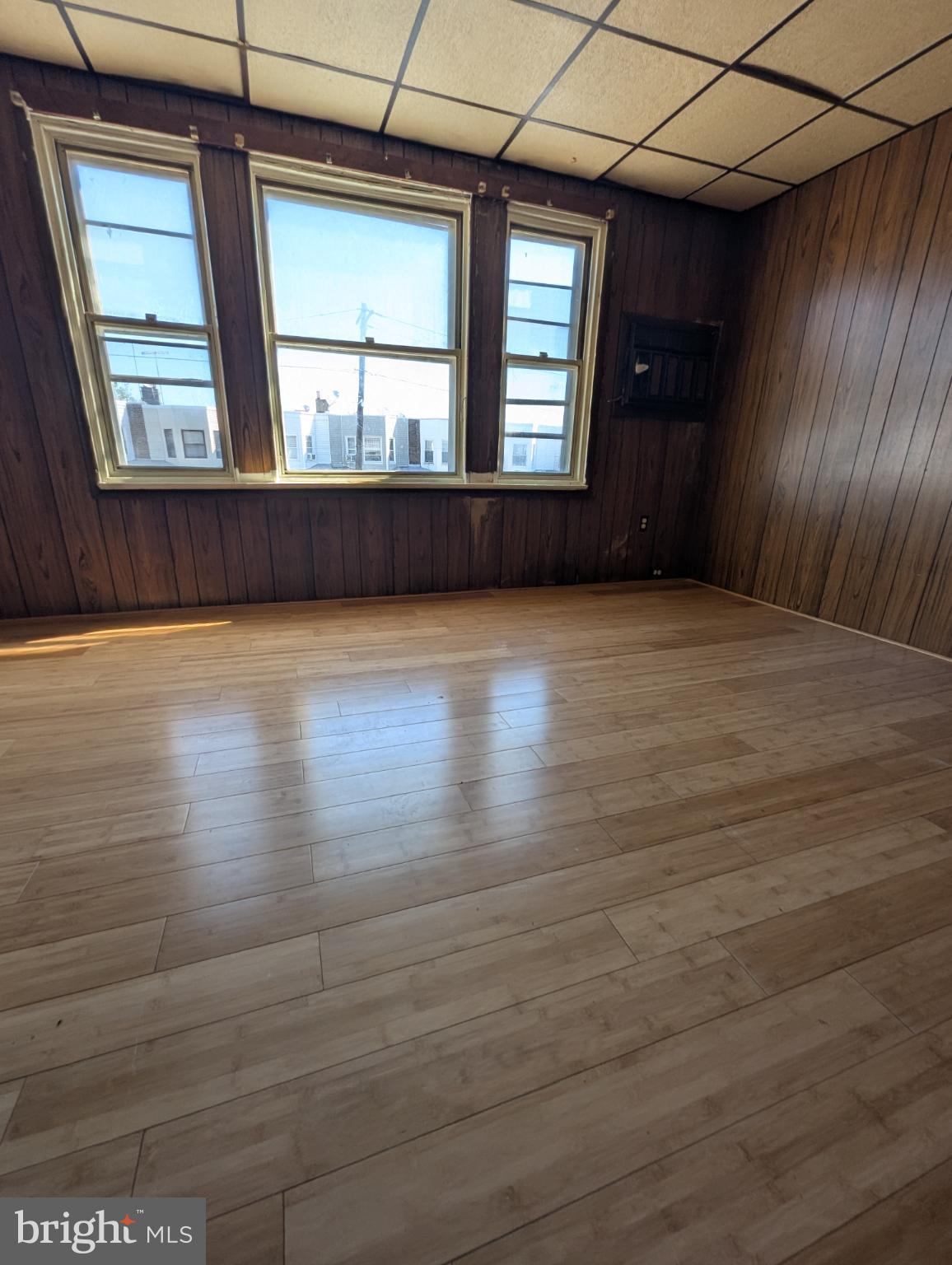 2650 South 68th Street Philadelphia, PA 19142 - Photo 8 of 12 an empty room with wooden floor and windows