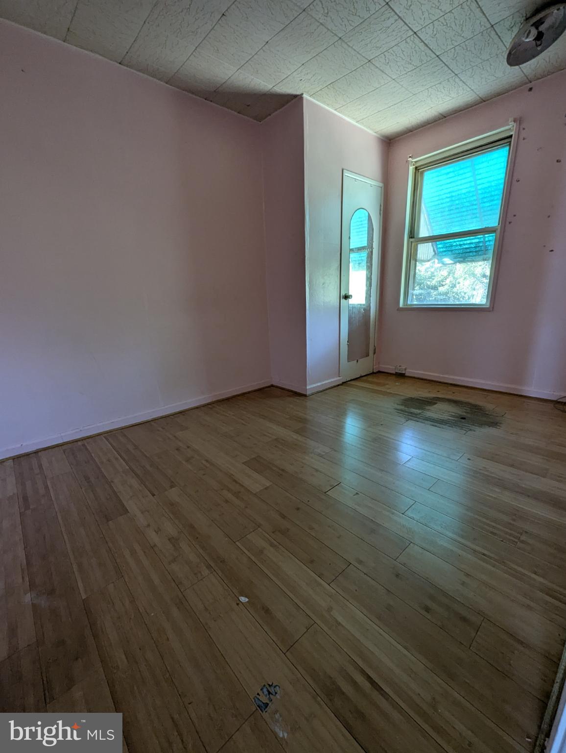 2650 South 68th Street Philadelphia, PA 19142 - Photo 9 of 12 a view of an empty room with wooden floor and a window