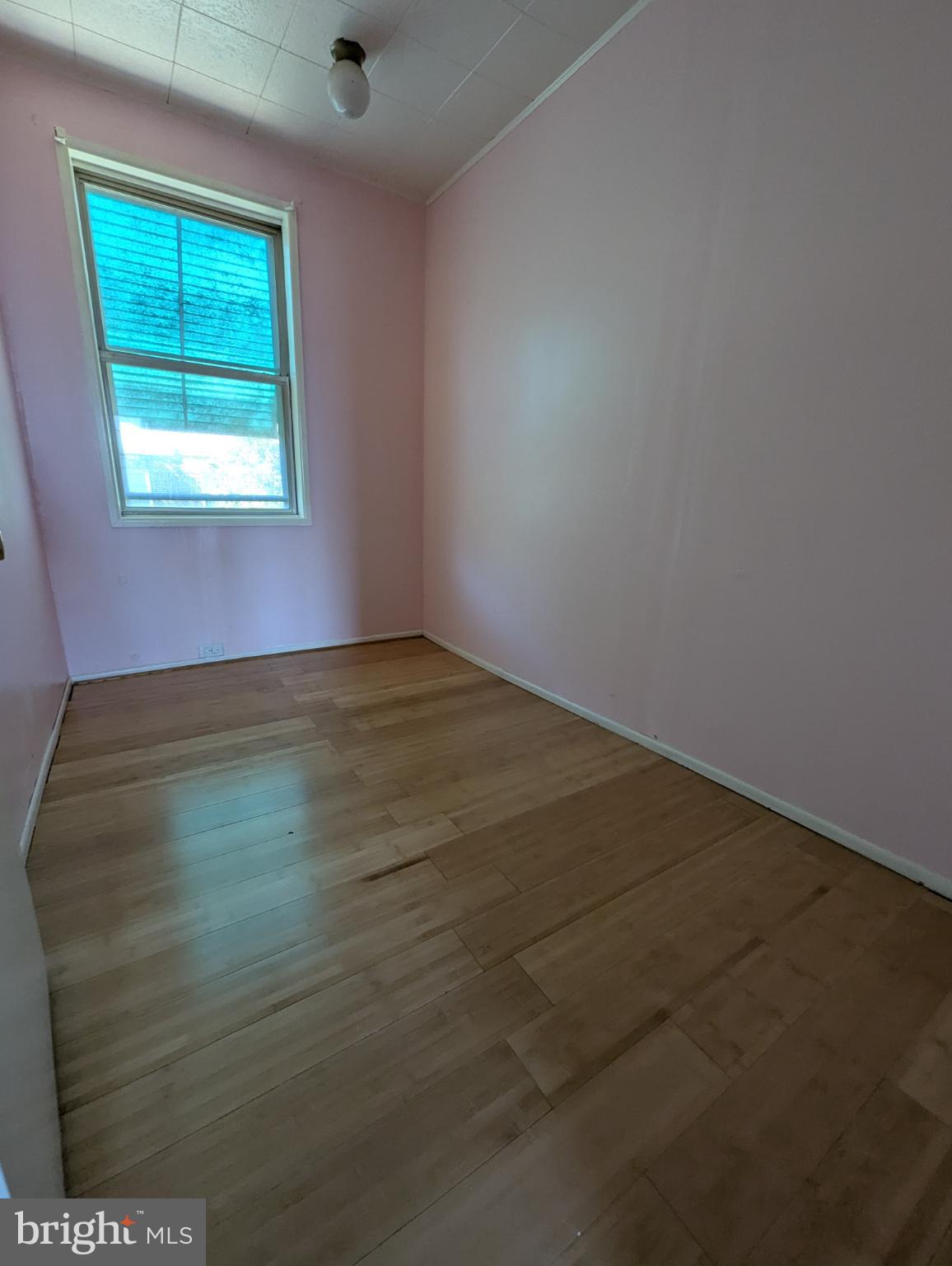 2650 South 68th Street Philadelphia, PA 19142 - Photo 10 of 12 an empty room with wooden floor and windows