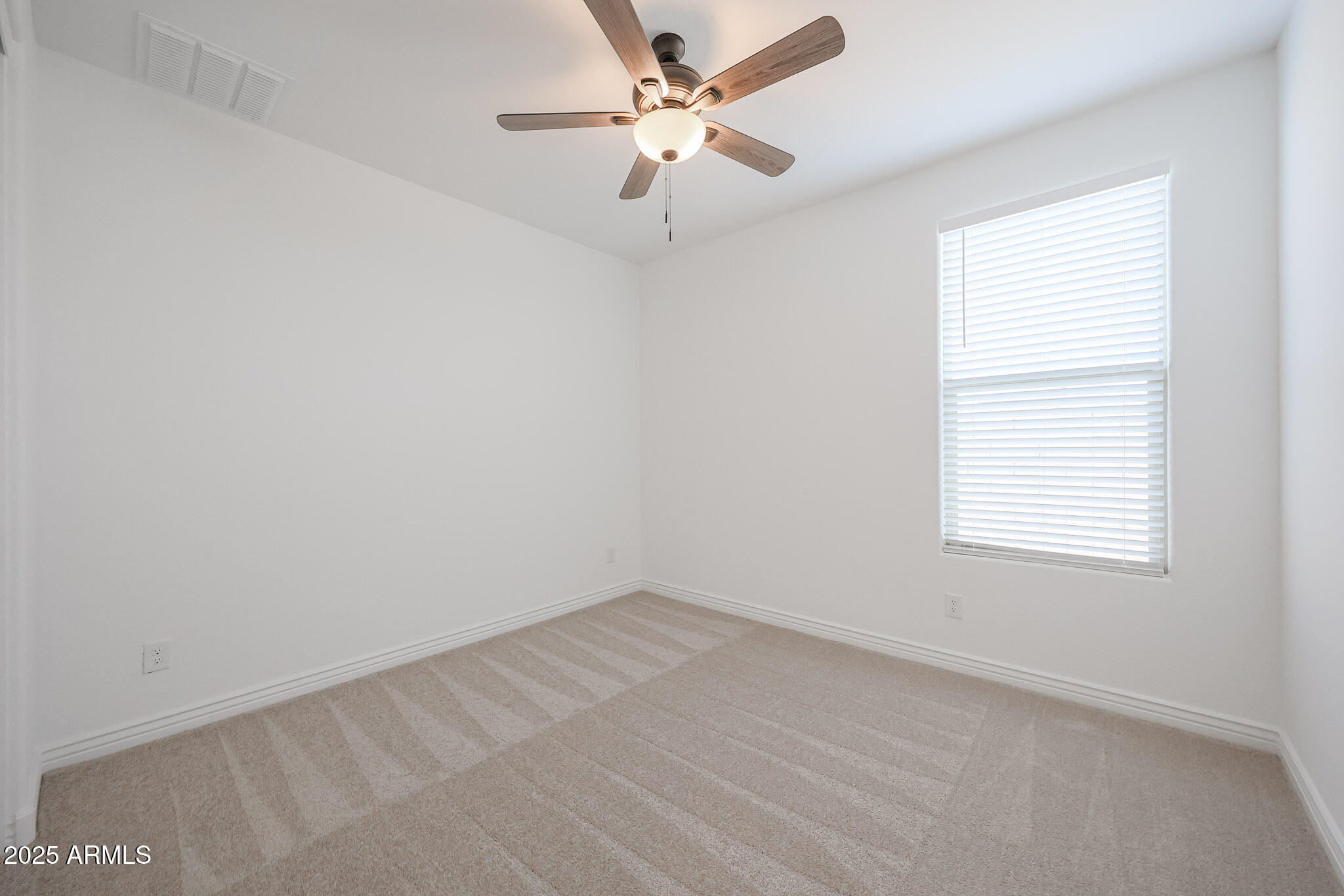 25110 North 170th Lane Surprise, AZ 85387 - Photo 13 of 20 an empty room with a window and a fan