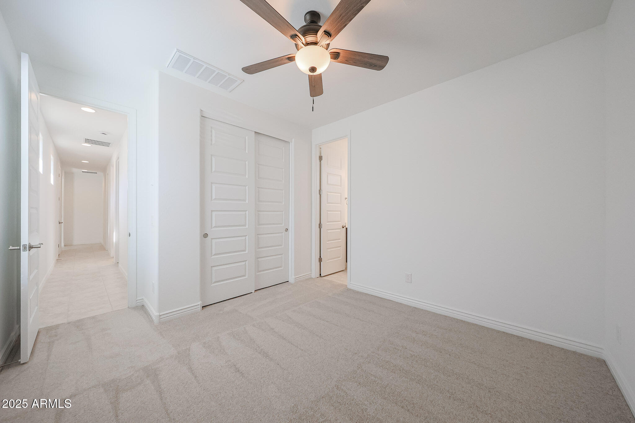 25110 North 170th Lane Surprise, AZ 85387 - Photo 15 of 20 an empty room with closet and fan