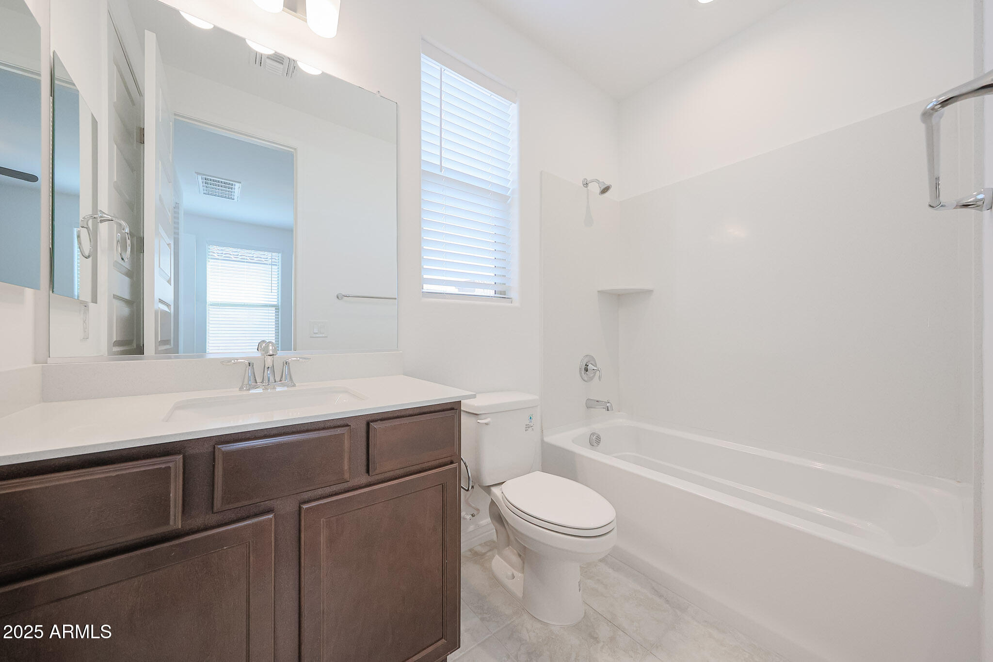 25110 North 170th Lane Surprise, AZ 85387 - Photo 16 of 20 a bathroom with a sink a toilet and bathtub