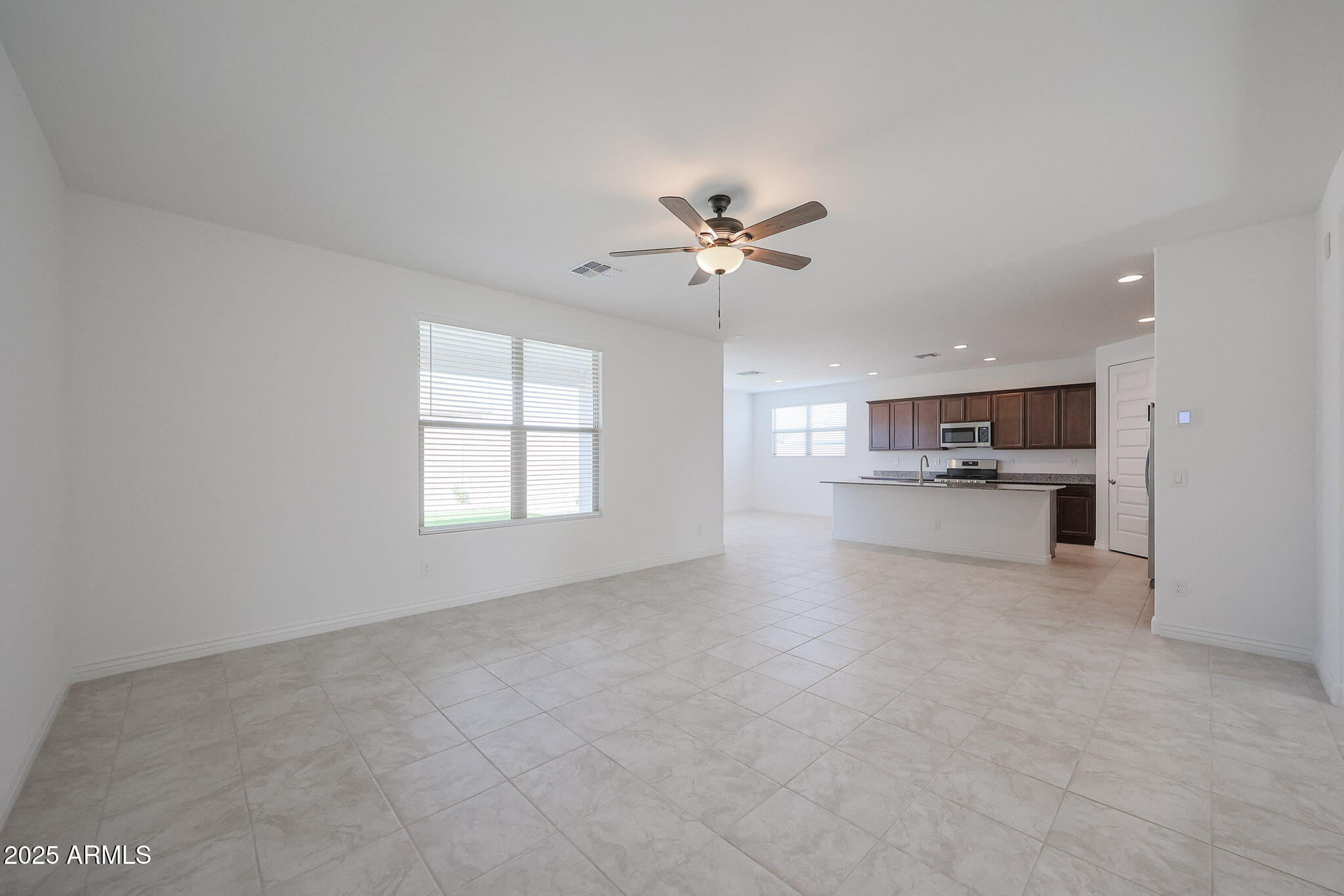 25110 North 170th Lane Surprise, AZ 85387 - Photo 6 of 20 a view of an empty room with a kitchen