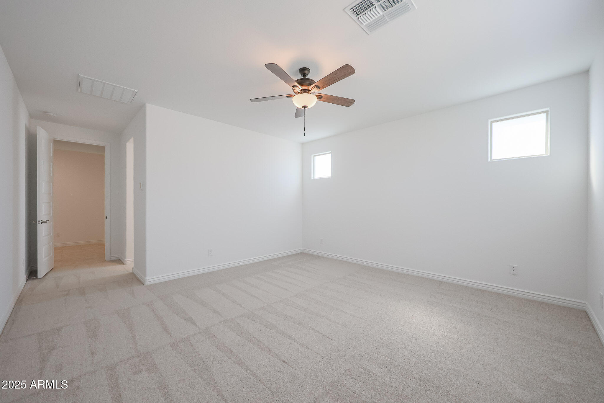 25110 North 170th Lane Surprise, AZ 85387 - Photo 9 of 20 an empty room with windows and fan