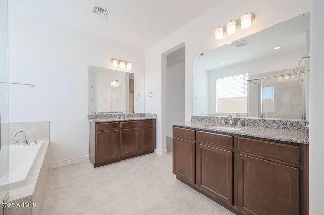 a spacious bathroom with a bathtub and shower