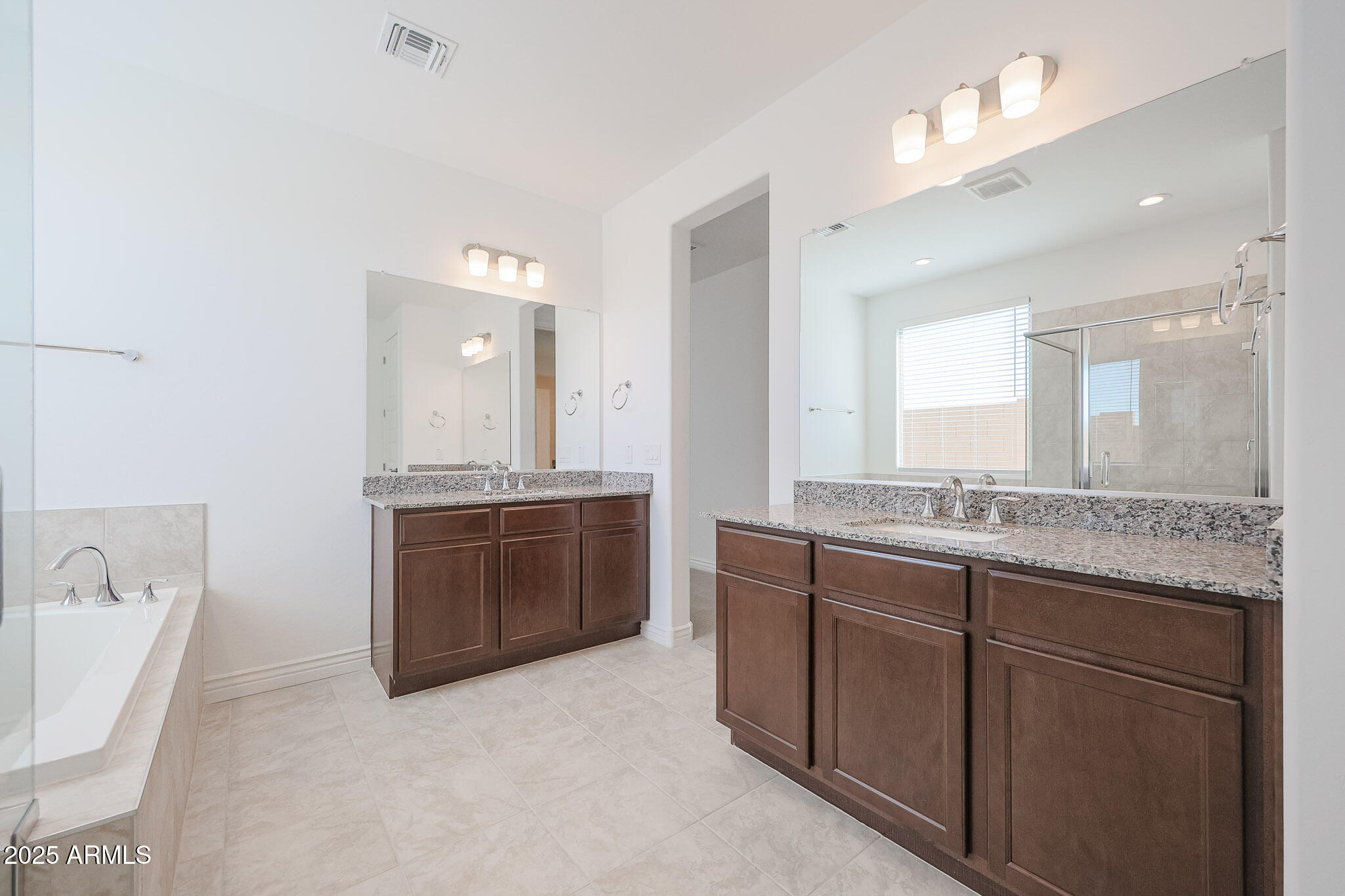 25110 North 170th Lane Surprise, AZ 85387 - Photo 10 of 20 a bathroom with a granite countertop double vanity sink a mirror and a bathtub
