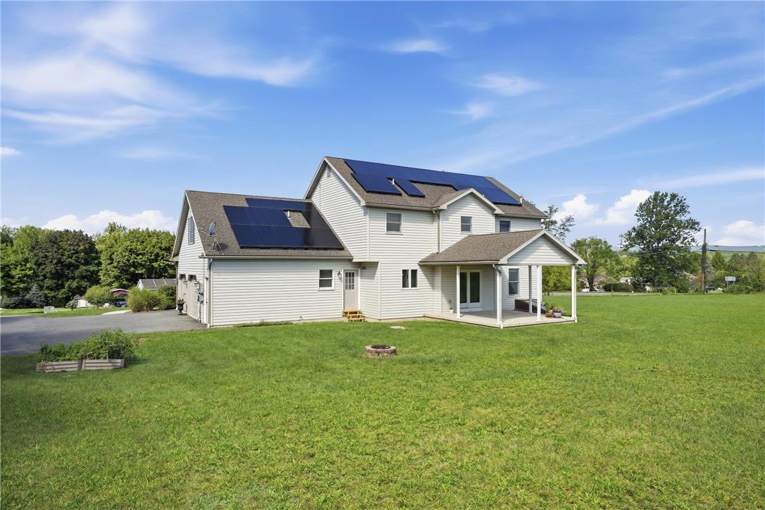 590 Fehr Road Nazareth, PA 18064 - Photo 64 of 79 A spacious green lawn surrounds this contemporary two-story home featuring solar panel integration.