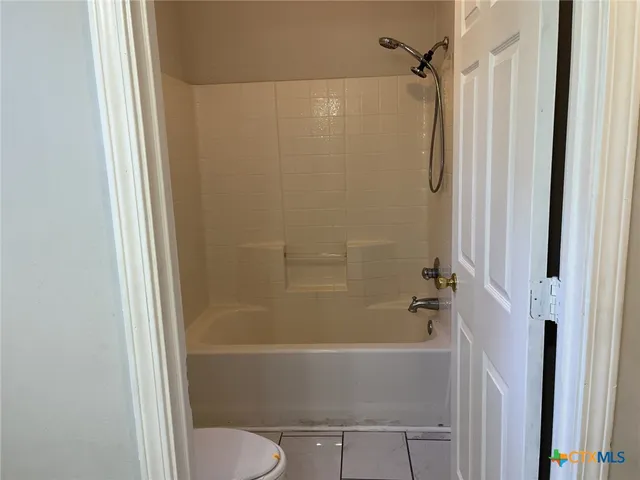 a bathroom with a shower and a toilet