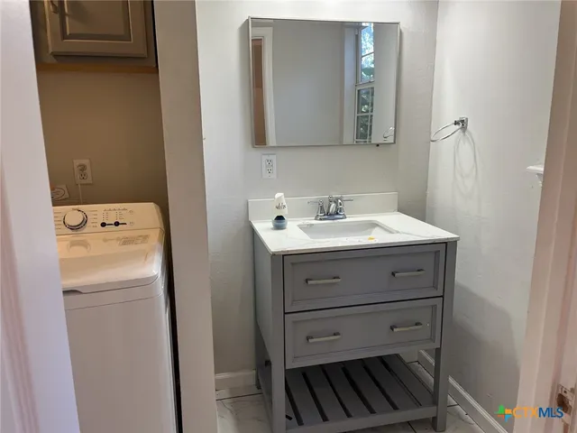 a bathroom with a sink and a mirror