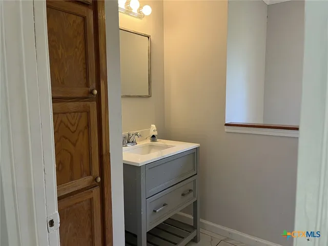 a bathroom with a sink a mirror and shower