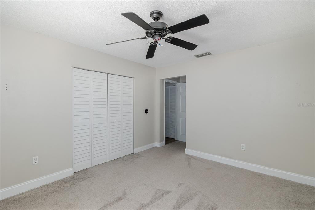7900 Hardwick Drive, Unit 827 New Port Richey, FL 34653 - Photo 21 of 27 an empty room with closet and ceiling fan