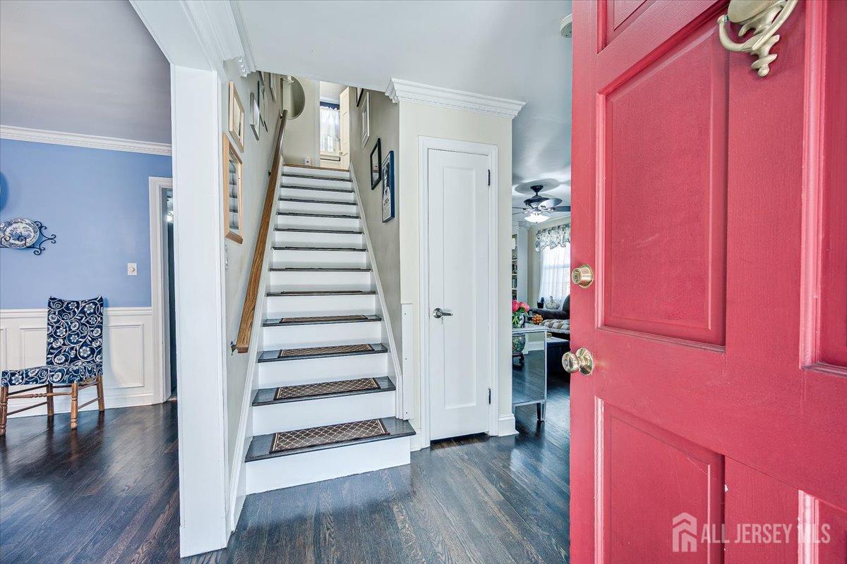137 5th Street Edison, NJ 08837 - Photo 12 of 52 a view of a hallway with wooden floor and stairs