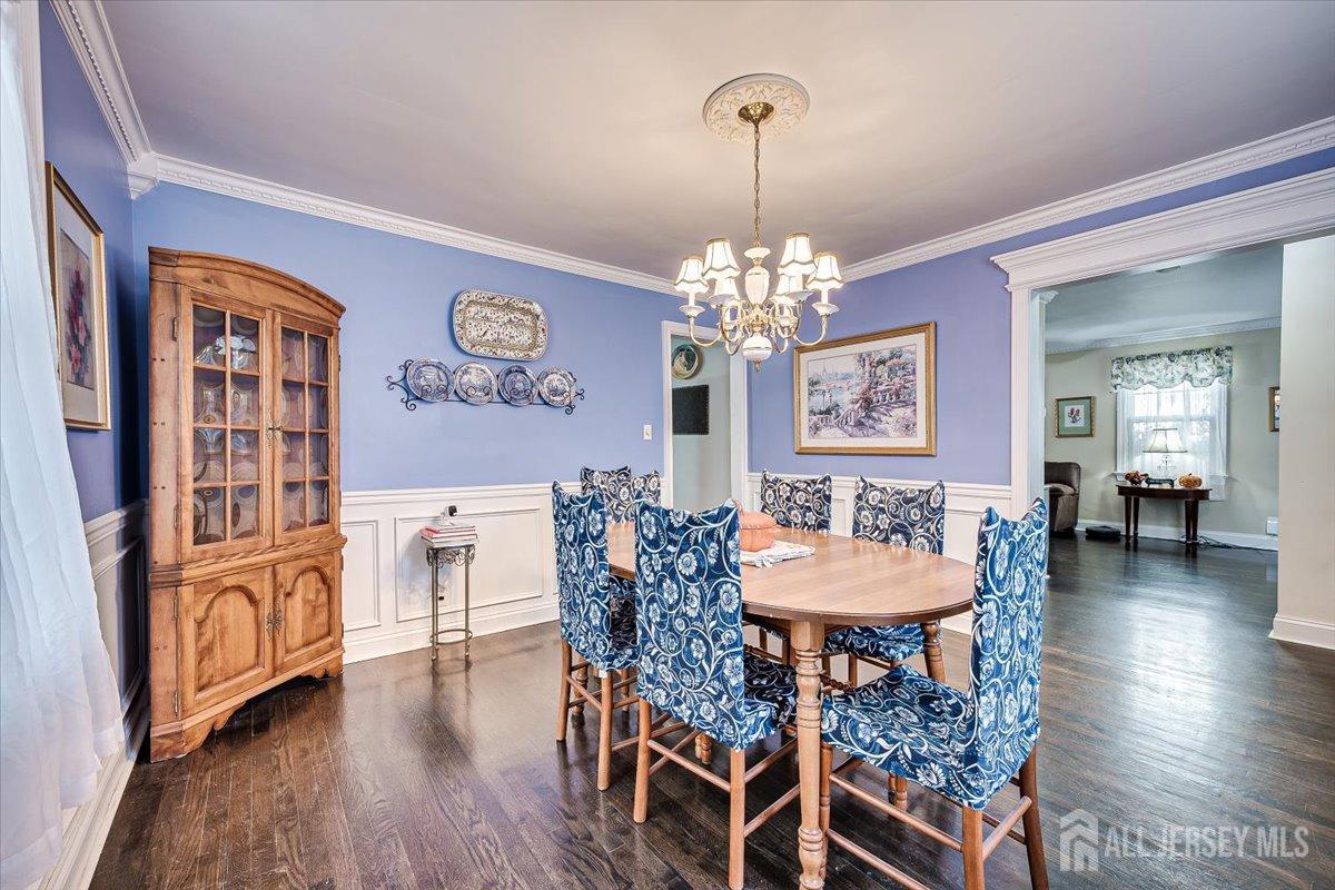 137 5th Street Edison, NJ 08837 - Photo 15 of 52 a view of a dining room with furniture wooden floor and chandelier