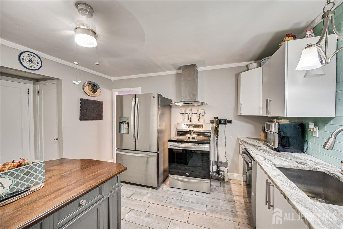 137 5th Street Edison, NJ 08837 - Photo 20 of 52 a kitchen with granite countertop a sink appliances and cabinets