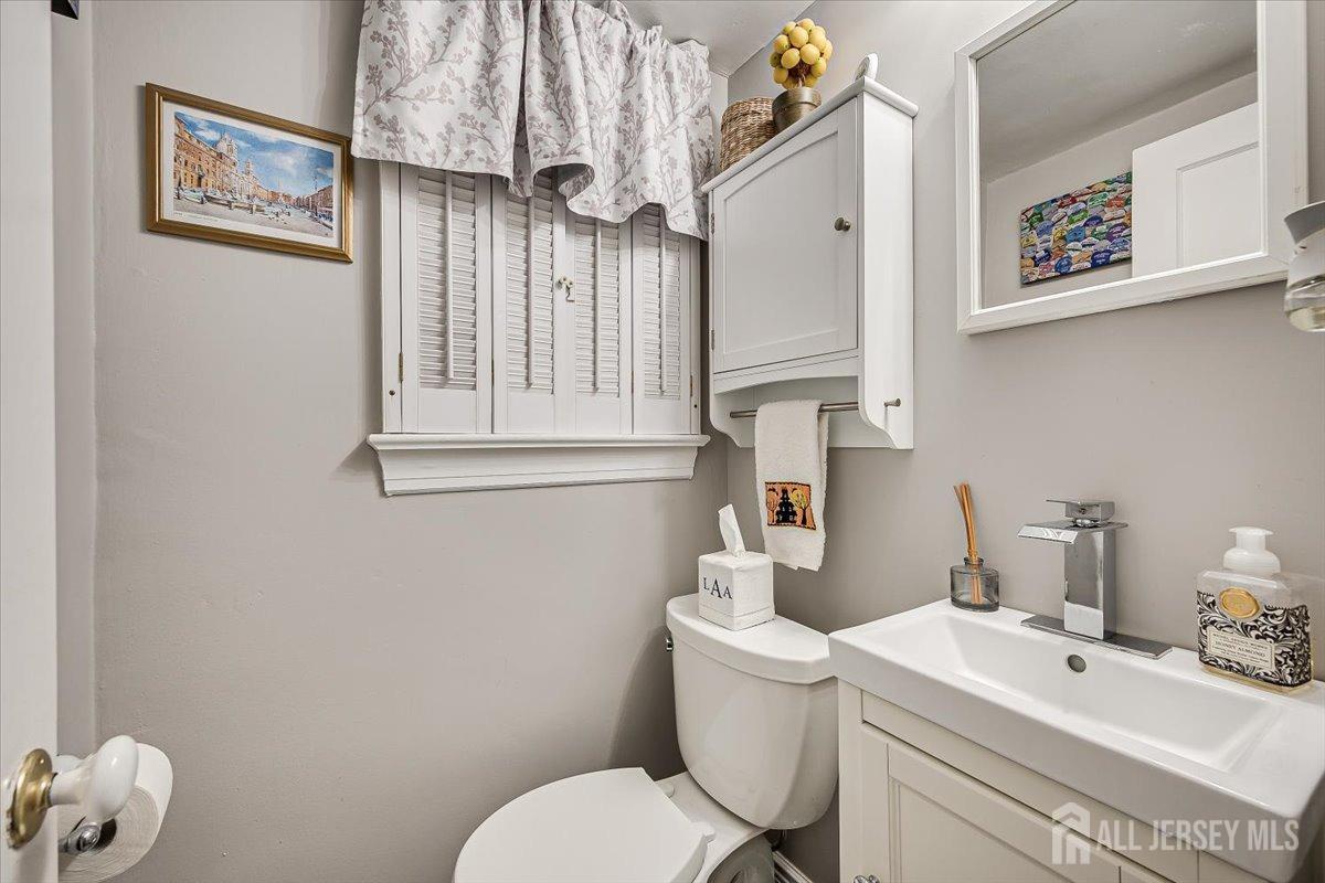 137 5th Street Edison, NJ 08837 - Photo 22 of 52 a bathroom with a sink mirror and toilet
