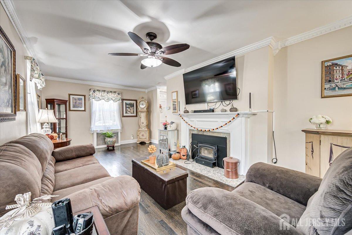 137 5th Street Edison, NJ 08837 - Photo 26 of 52 a living room with furniture a fireplace a flat screen tv and a window