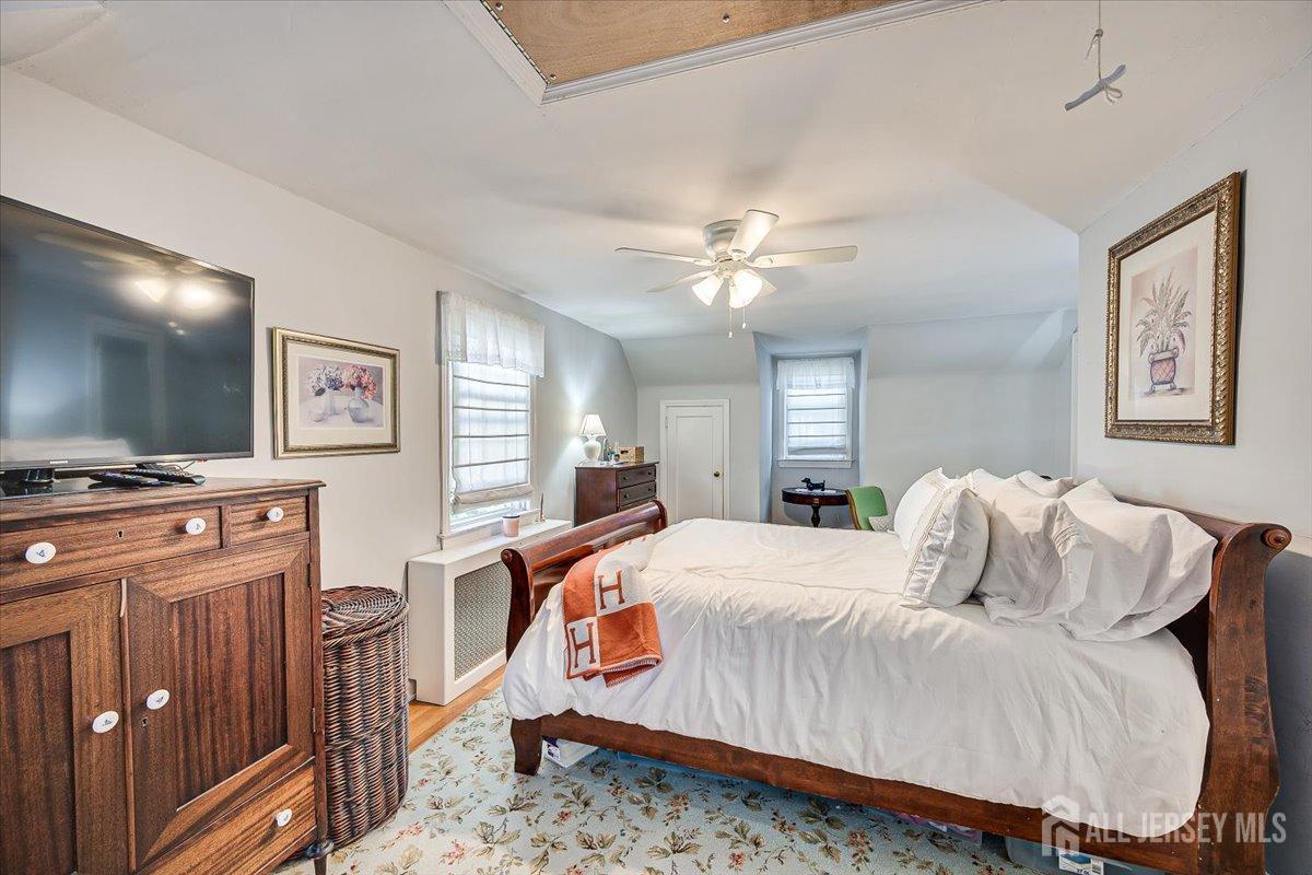 137 5th Street Edison, NJ 08837 - Photo 28 of 52 a bedroom with a bed and a flat screen tv