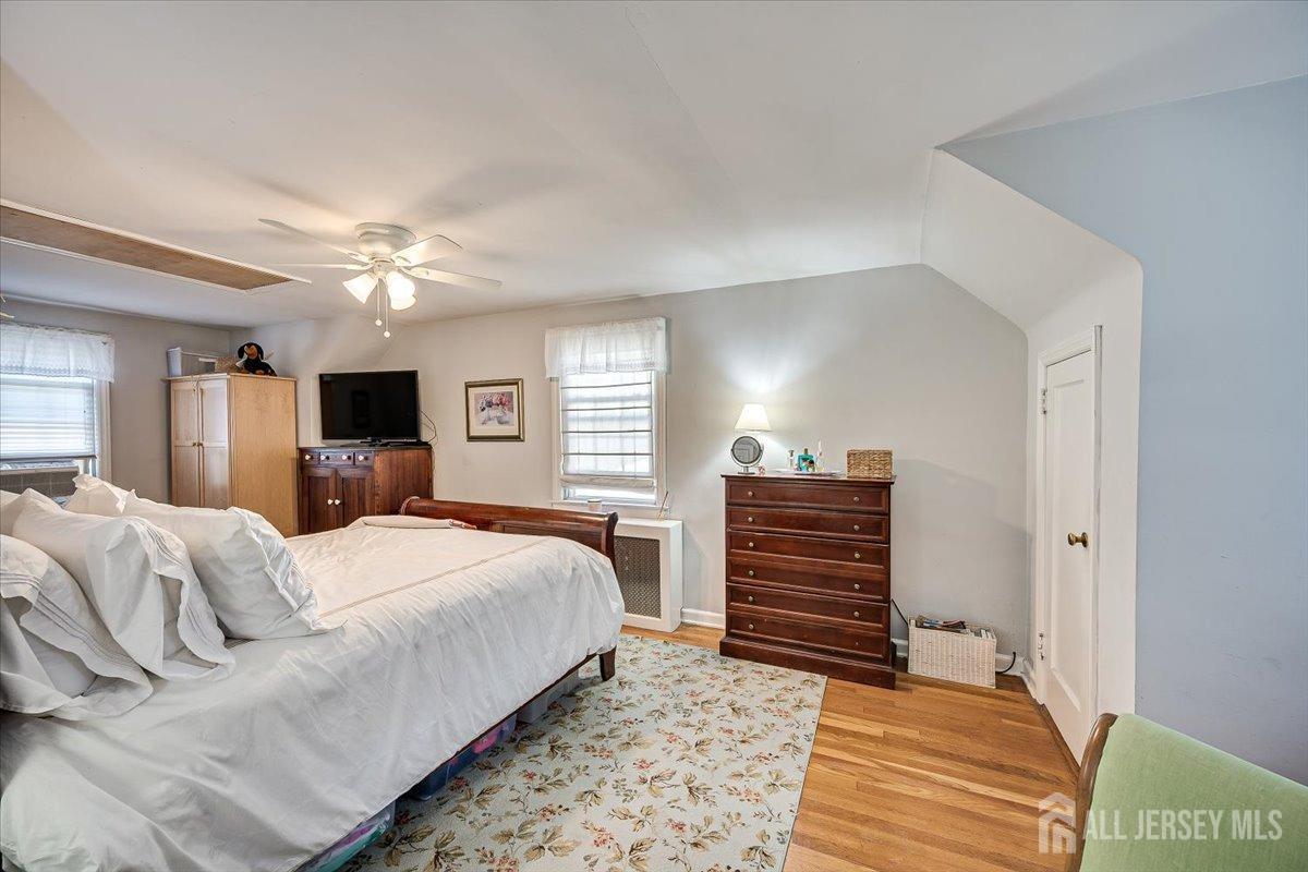 137 5th Street Edison, NJ 08837 - Photo 30 of 52 a bedroom with a bed and wooden floor