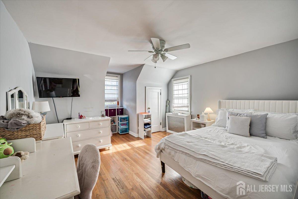 137 5th Street Edison, NJ 08837 - Photo 32 of 52 a bedroom with furniture a bed and a flat screen tv