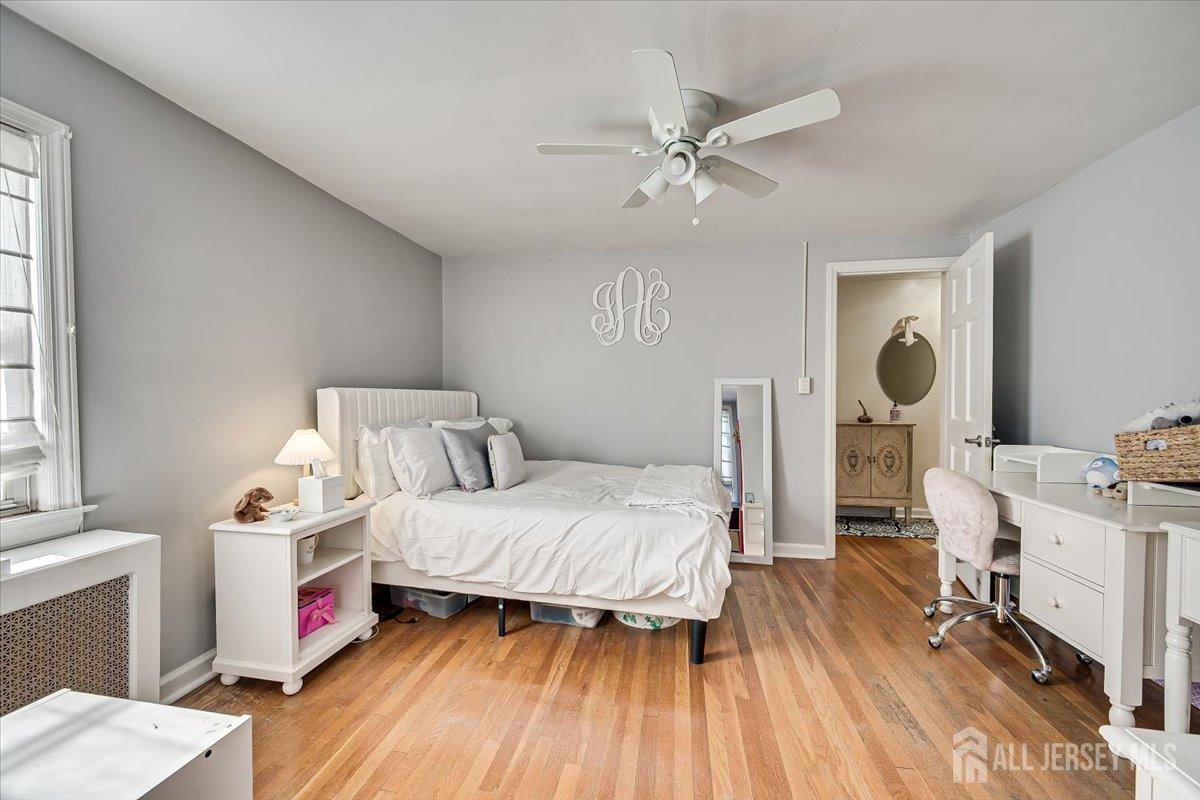137 5th Street Edison, NJ 08837 - Photo 34 of 52 a bedroom with a bed and wooden floor