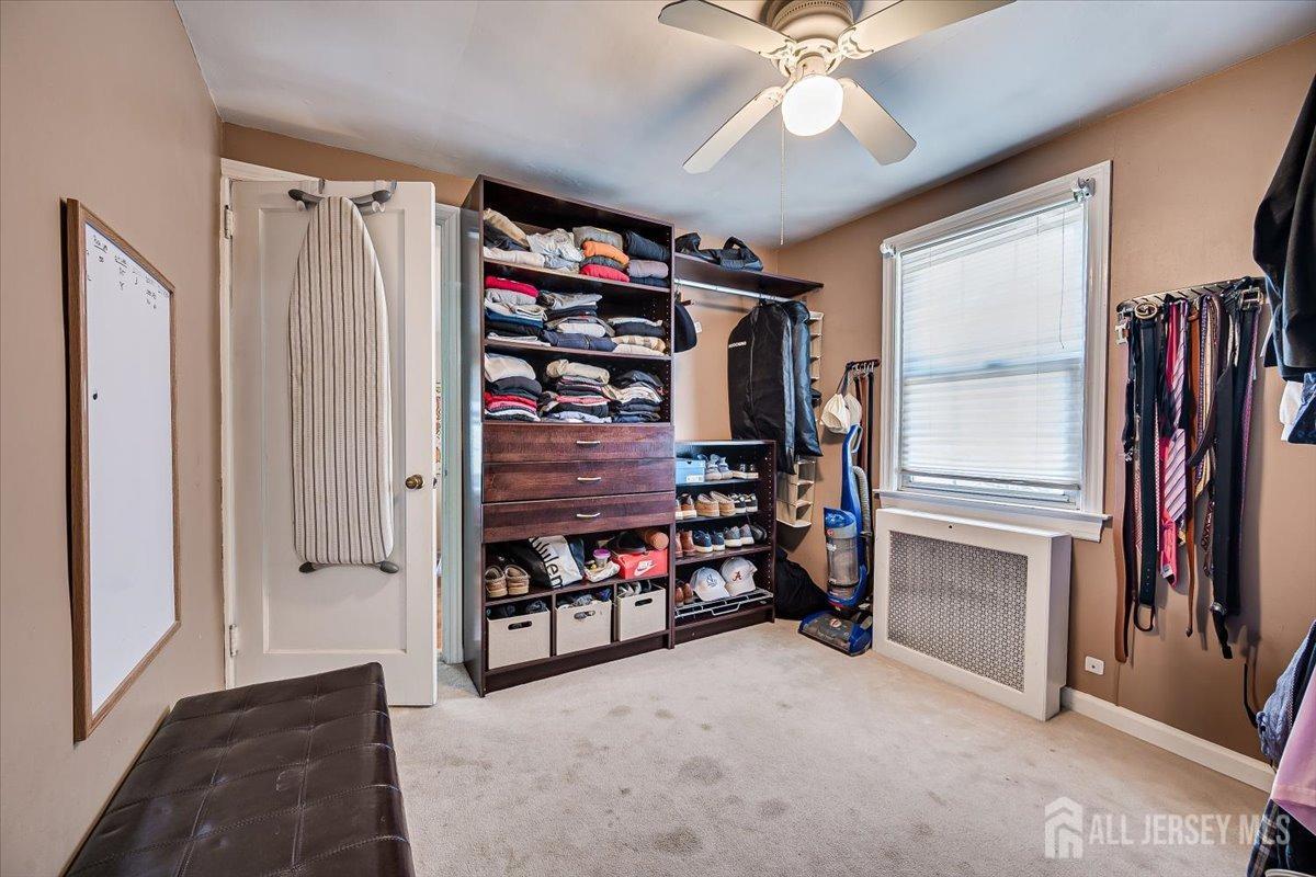 137 5th Street Edison, NJ 08837 - Photo 35 of 52 a view of a livingroom with furniture and a ceiling fan