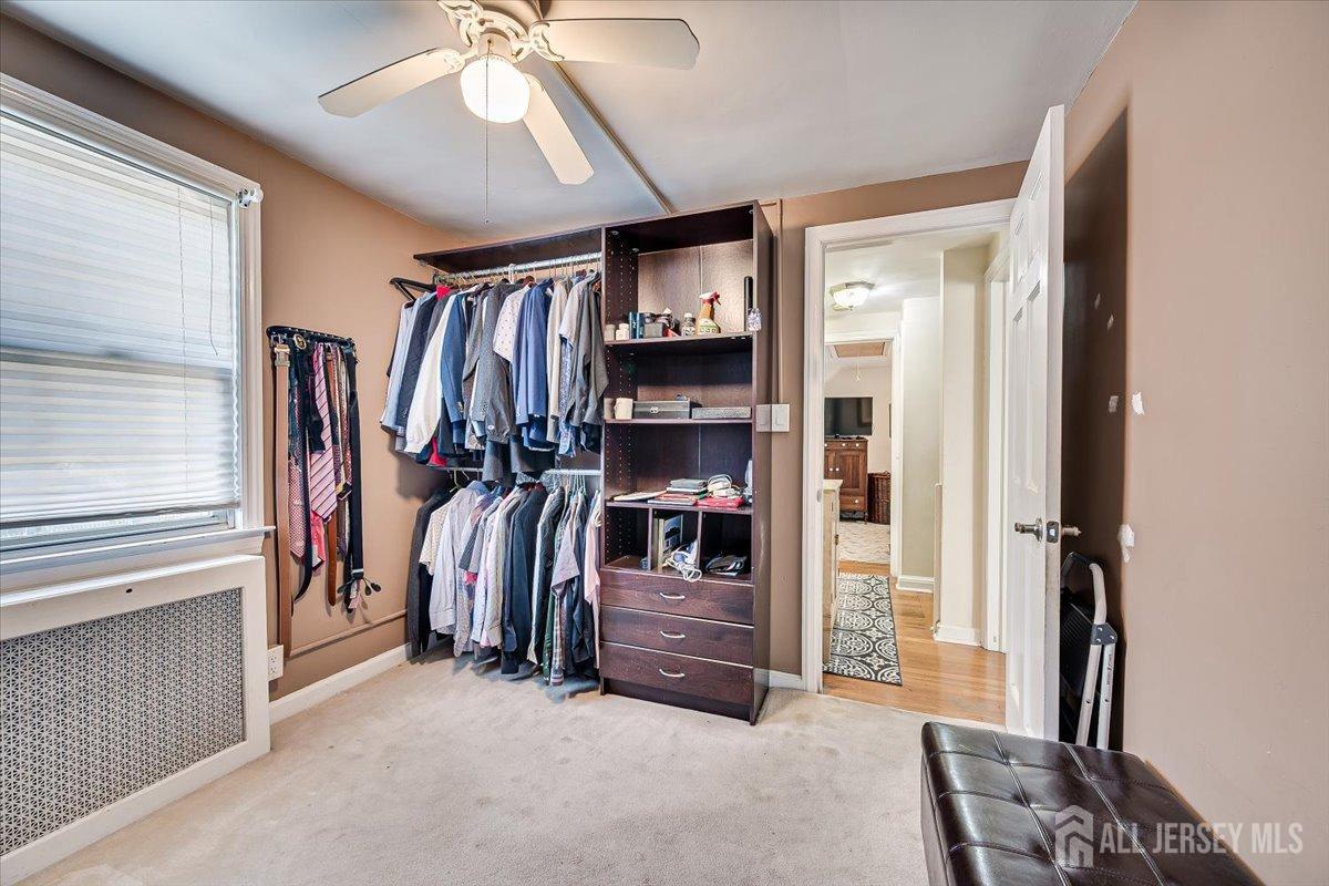 137 5th Street Edison, NJ 08837 - Photo 36 of 52 a view of walk in closet with clothes and shoes