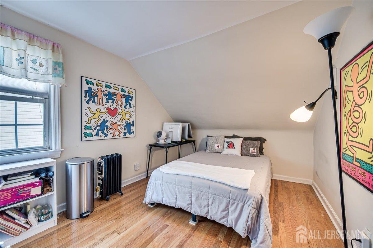 137 5th Street Edison, NJ 08837 - Photo 37 of 52 a bedroom with a bed and a flat screen tv