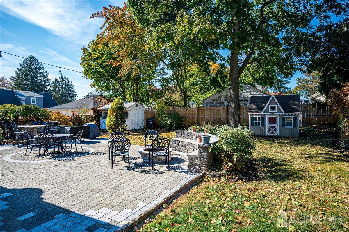 137 5th Street Edison, NJ 08837 - Photo 44 of 52 a view of a patio with table and chairs potted plants and large tree