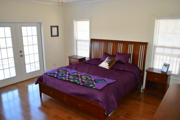 357 Sam Reed Road Northwest Floyd, VA 24091 - Photo 30 of 105 a bedroom with a bed and wooden floor