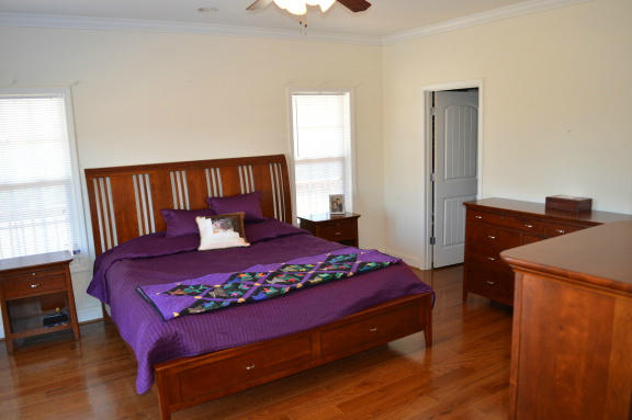 357 Sam Reed Road Northwest Floyd, VA 24091 - Photo 31 of 105 a bedroom with a large bed and a lamp on table