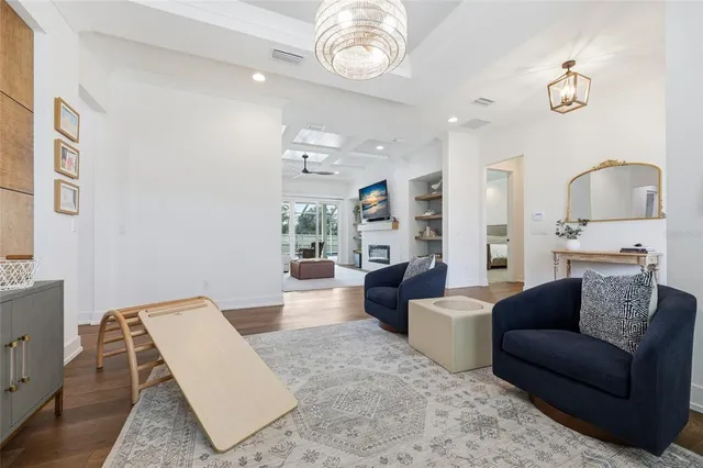a living room with furniture and a chandelier