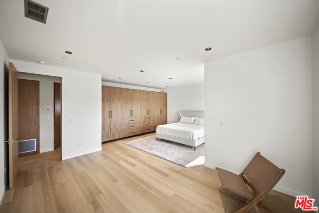 a bedroom with a bed and a chair