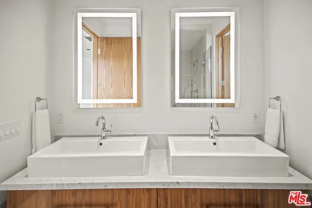 a bathroom with double vanity sinks and a bathtub