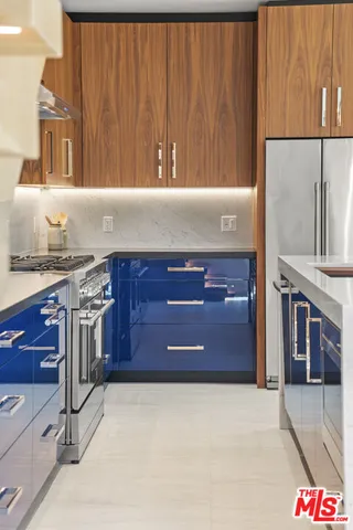a kitchen with granite countertop a stove and cabinets