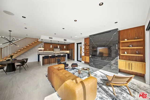a living room with furniture a rug and white walls