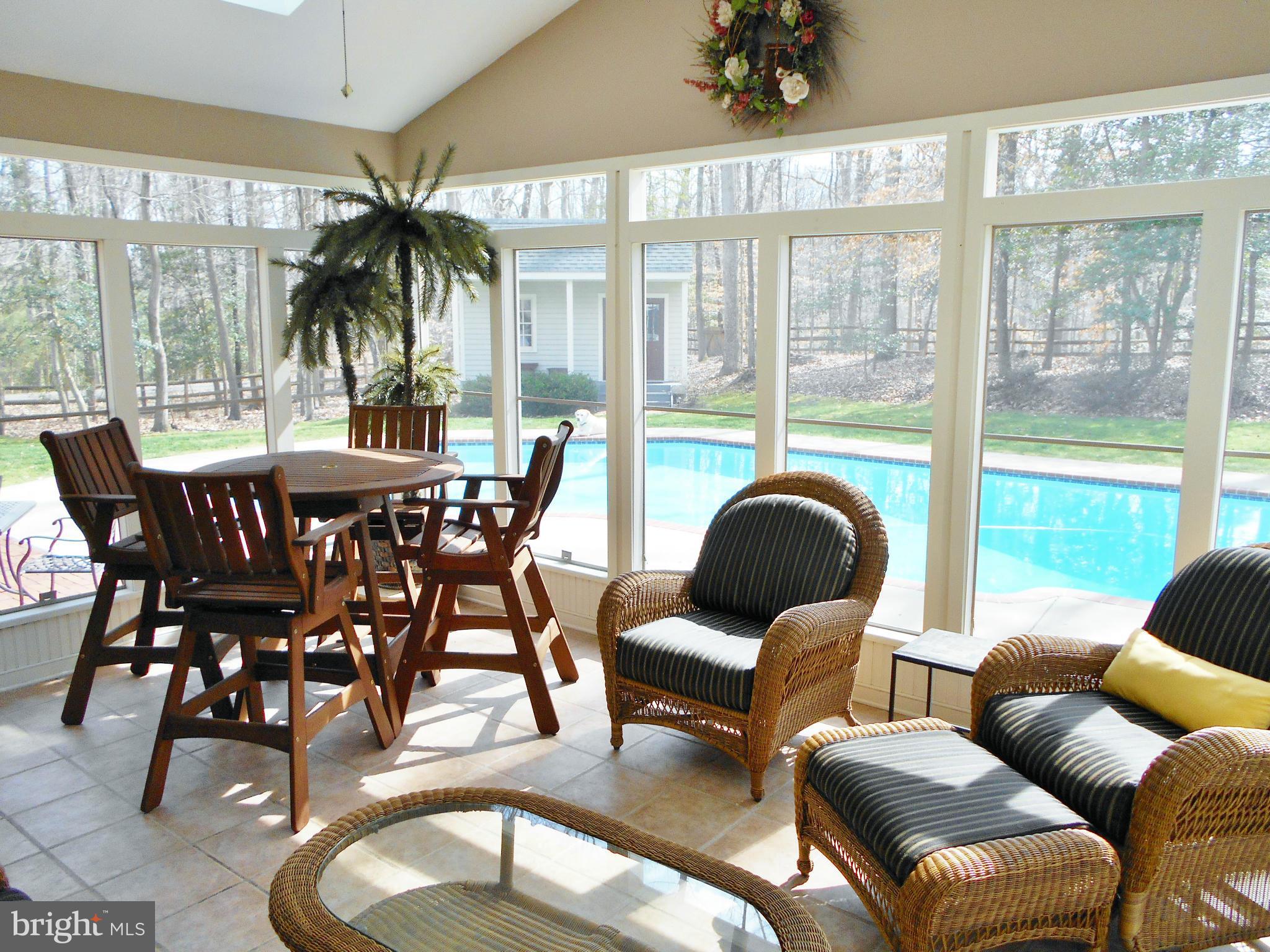 7415 Simms Landing Road Port Tobacco, MD 20677 - Photo 1 of 30 a dining room with furniture and large windows
