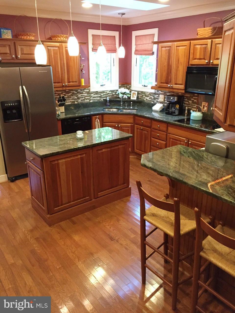7415 Simms Landing Road Port Tobacco, MD 20677 - Photo 12 of 30 a kitchen with stainless steel appliances granite countertop a sink stove and microwave