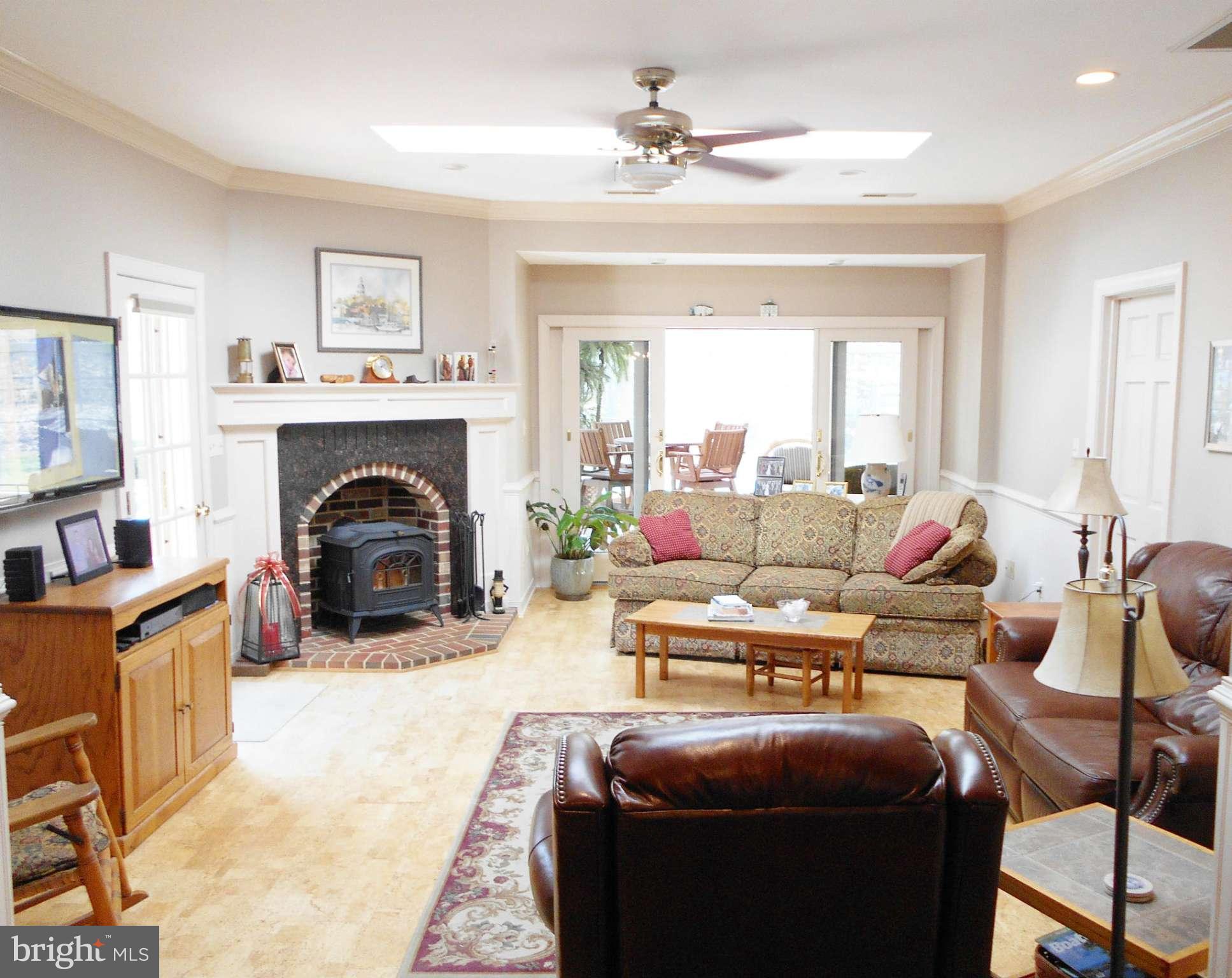 7415 Simms Landing Road Port Tobacco, MD 20677 - Photo 15 of 30 a living room with furniture a fireplace and a window