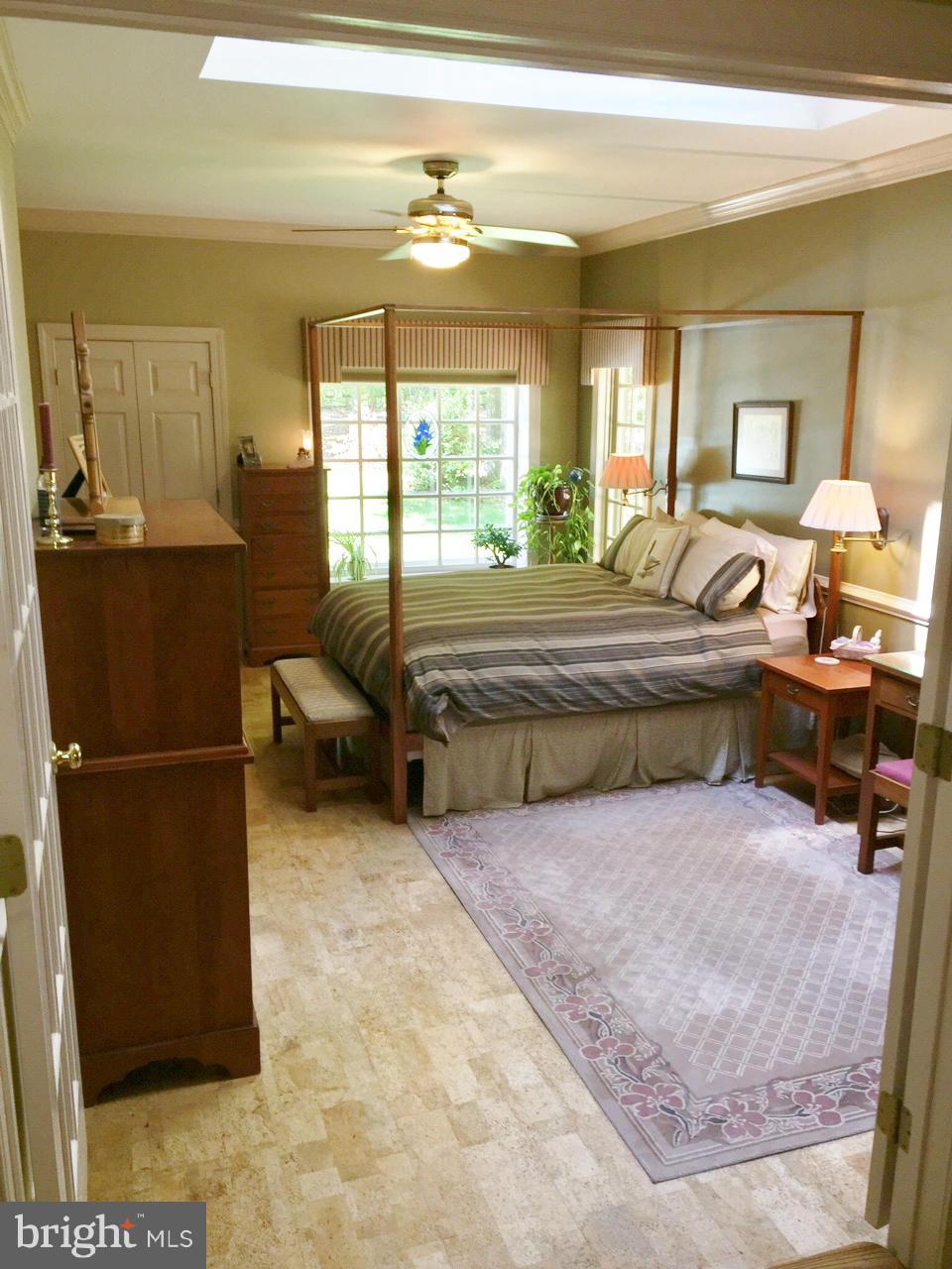 7415 Simms Landing Road Port Tobacco, MD 20677 - Photo 21 of 30 a living room with a bed furniture and a large window