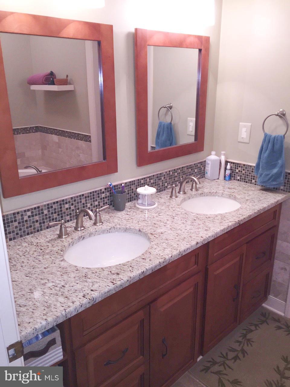 7415 Simms Landing Road Port Tobacco, MD 20677 - Photo 23 of 30 a bathroom with a granite countertop double vanity sink and two mirror