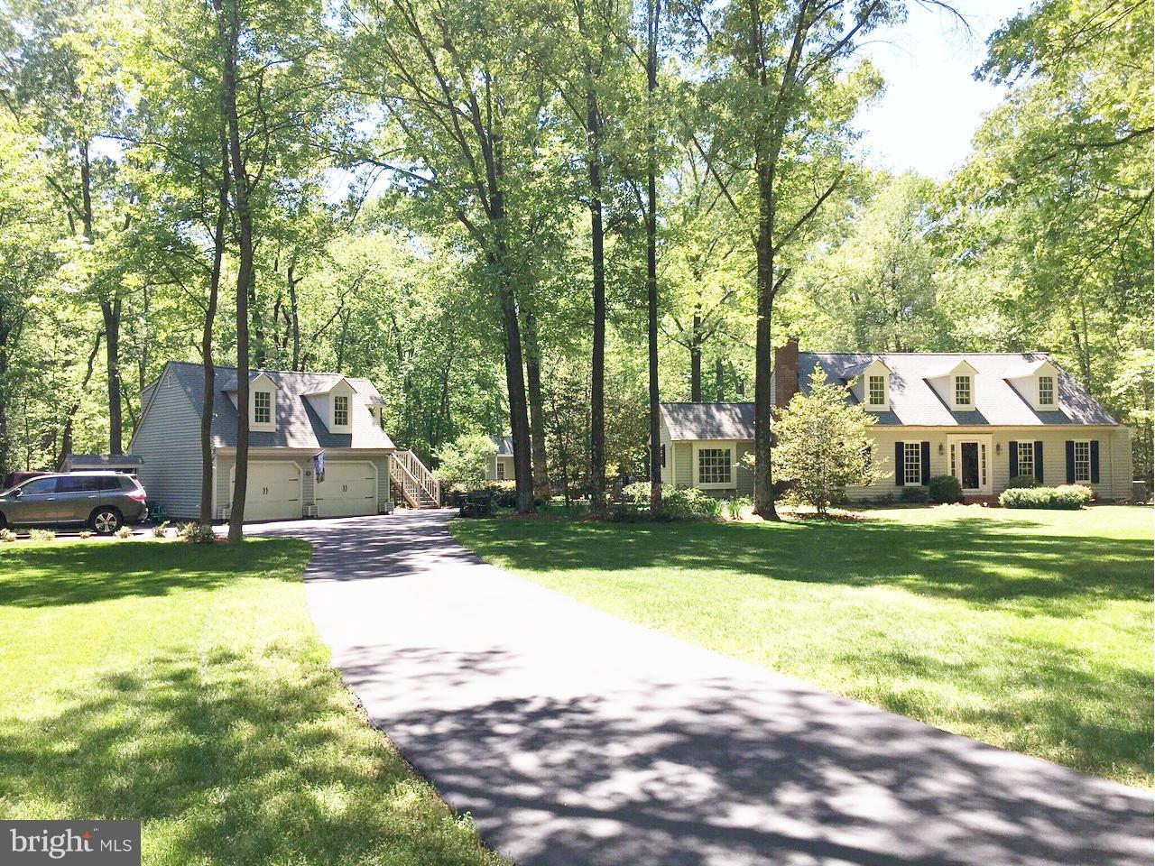 7415 Simms Landing Road Port Tobacco, MD 20677 - Photo 4 of 30 a view of a house with a yard and tree s
