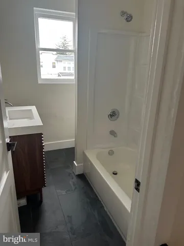 a bathroom with a bathtub sink and toilet