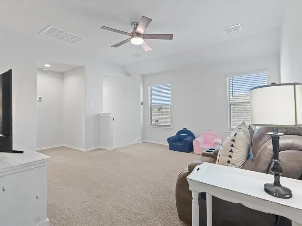 a bedroom with a bed and ceiling fan
