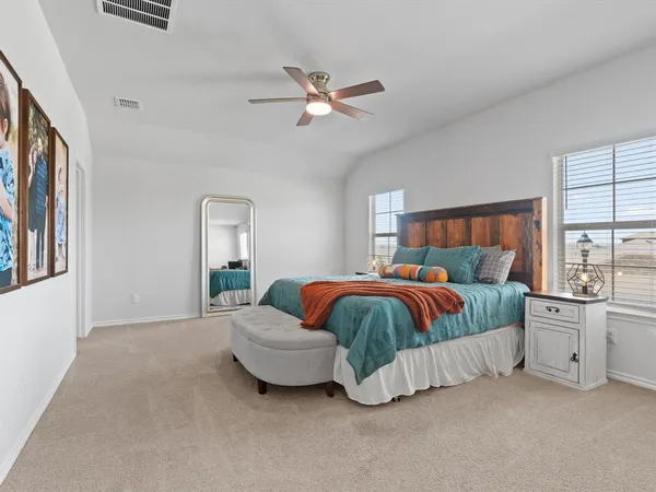 a spacious bedroom with a bed and window