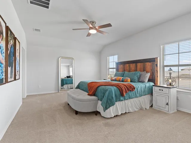 a spacious bedroom with a bed and window