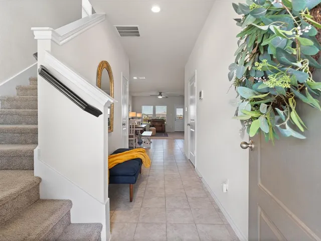 a hallway with a dining table and chairs