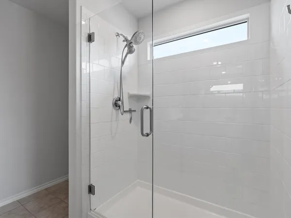 a bathroom with a shower and a bath tub
